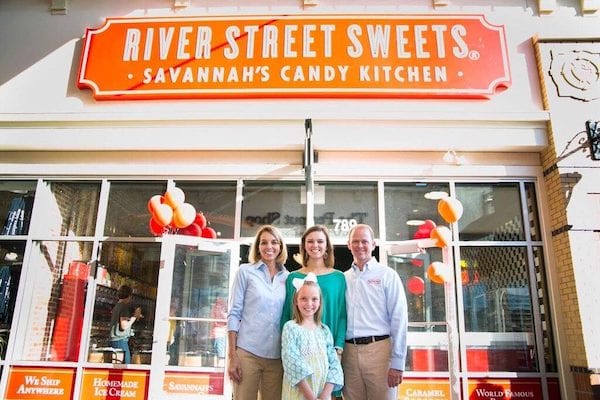 franchise family in front of River street sweets candy store